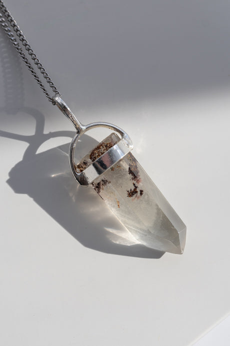 Crystal pendant necklace on a white background