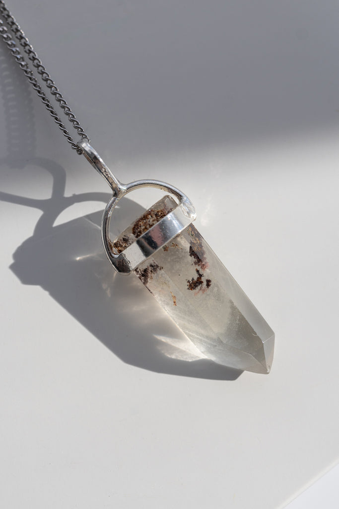 Crystal pendant necklace on a white background