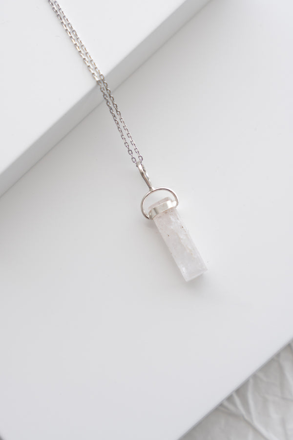 Crystal necklace on a white surface