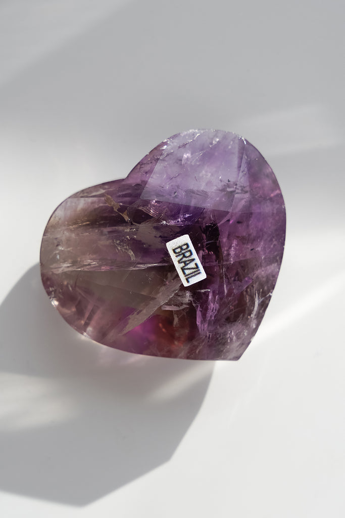 Heart-shaped purple gemstone with 'Brazil' label on a white background