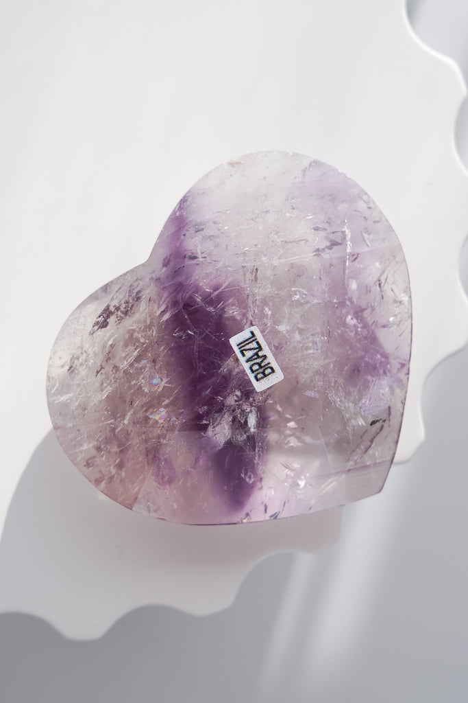 Heart-shaped purple crystal with a 'BRAZIL' label on a white background