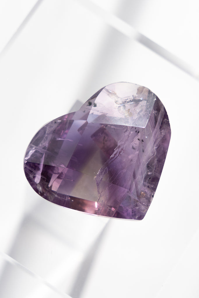 Purple gemstone on a white background