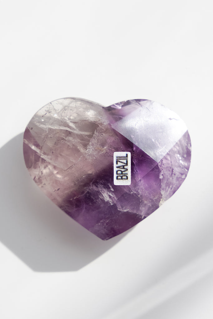 Heart-shaped purple crystal with 'BRAZIL' label on a white background