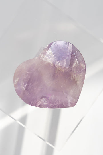 Heart-shaped purple stone on a white background