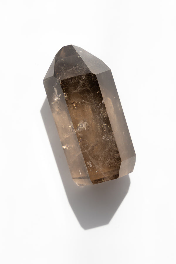 Smoky quartz crystal on a white background