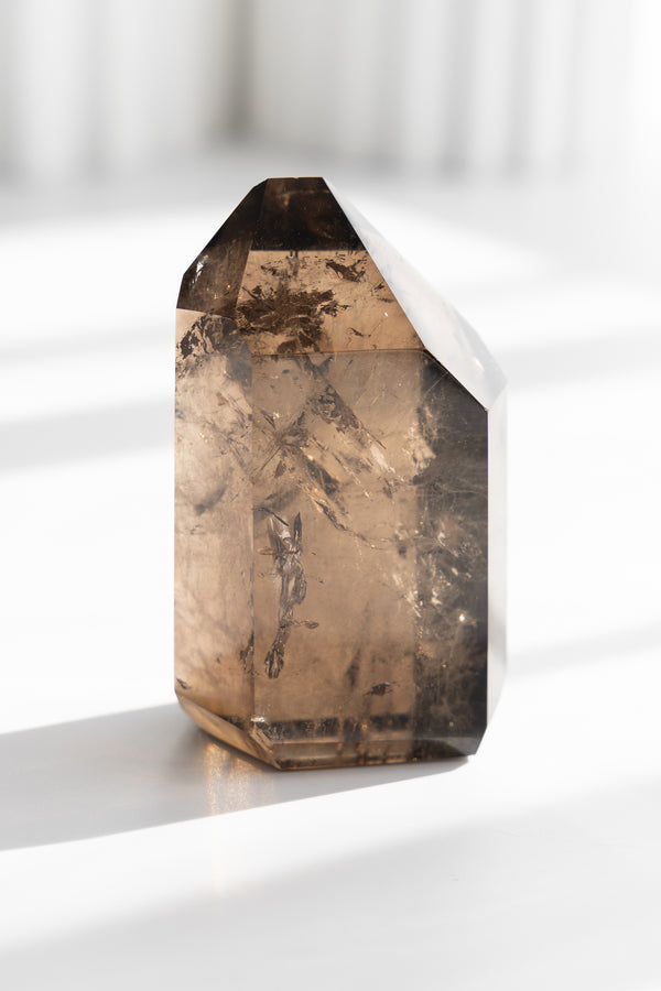 Smoky quartz crystal on a white background